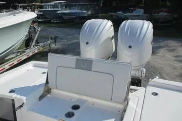 Slide: The Image of 2026 Sea Fox 282 Hybrid LT boat with dual outboard engines, docked in a marina. - 8