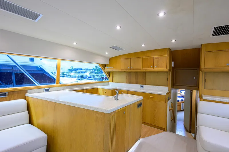 Slide: The Image of Interior of a 1998 Bertram 54 yacht with wooden cabinetry and modern lighting. - 11