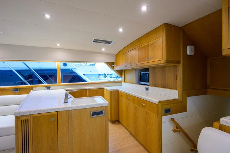 Slide: The Image of Luxurious interior of a 1998 Bertram 54 yacht with modern kitchen and wooden cabinetry. - 13
