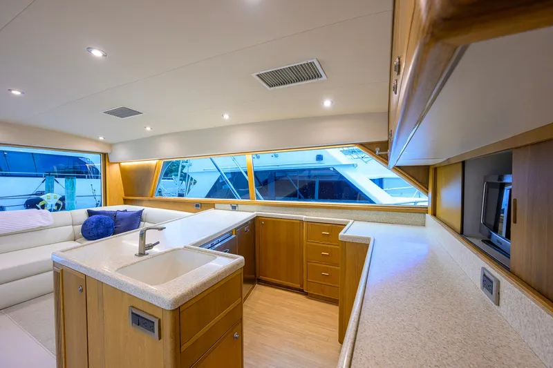 Slide: The Image of Luxurious interior of a 1998 Bertram 54 yacht with modern kitchen and seating area. - 14
