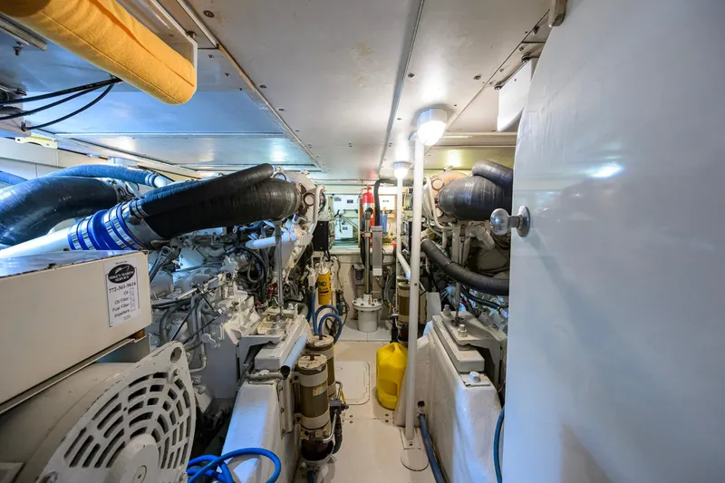 Slide: The Image of Engine room of a 1998 Bertram 54 yacht, showcasing machinery and equipment. - 33
