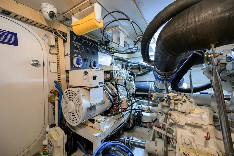 Slide: The Image of Engine room of a 1998 Bertram 54 yacht, showcasing machinery and equipment. - 37