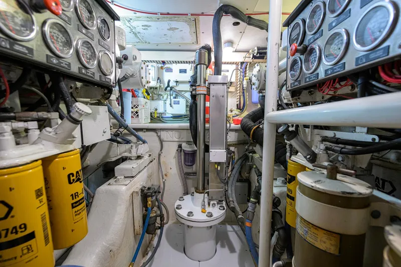 Slide: The Image of Engine room of a 1998 Bertram 54 yacht, featuring gauges and machinery. - 38