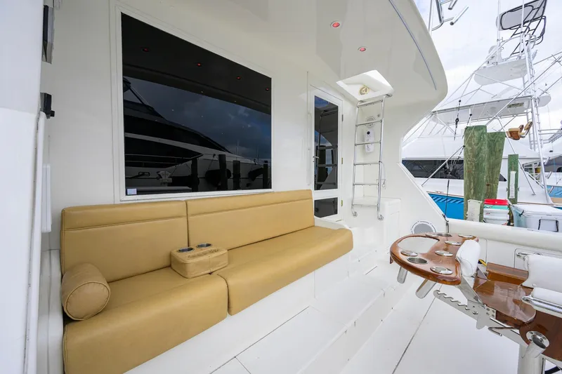 Slide: The Image of Luxurious 1998 Bertram 54 yacht interior with beige seating and polished wood table. - 5