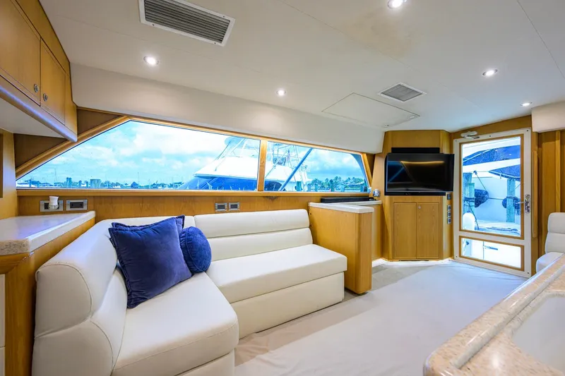 Slide: The Image of Luxurious interior of a 1998 Bertram 54 yacht with plush seating and large windows. - 6