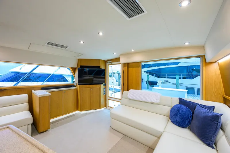 Slide: The Image of Luxurious interior of a 1998 Bertram 54 yacht with modern furnishings and large windows. - 9