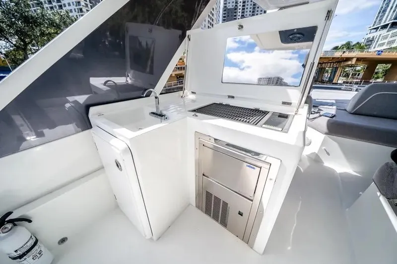 Slide: The Image of 2024 Galeon 500 Fly yacht kitchenette with sink, grill, and storage. - 19
