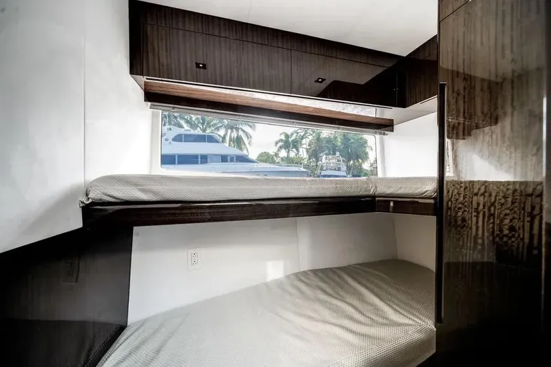 Slide: The Image of 2024 Galeon 500 Fly yacht interior with bunk beds and window view. - 52