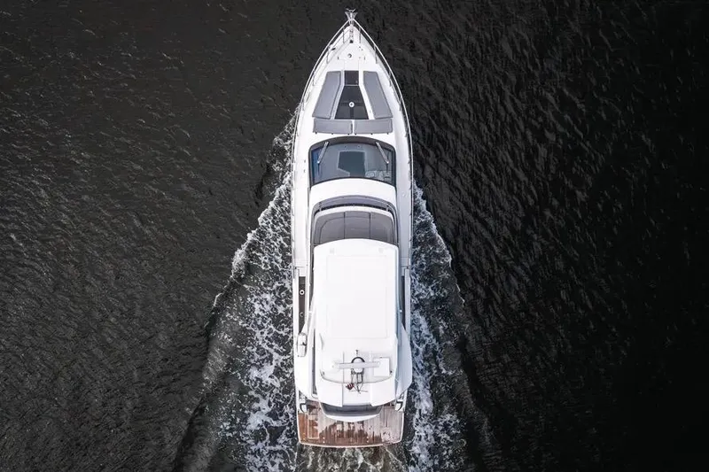 Slide: The Image of Aerial view of 2024 Galeon 500 Fly yacht cruising on dark water. - 8