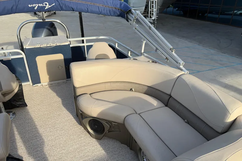 Slide: The Image of 2019 Avalon Venture Fish N Cruise 20' pontoon boat with beige seating and blue canopy. - 10