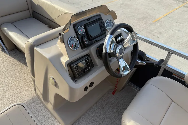 Slide: The Image of 2019 Avalon Venture Fish N Cruise boat dashboard with steering wheel and controls. - 14