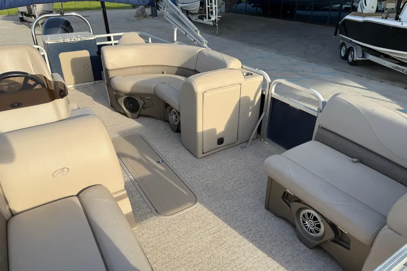Slide: The Image of 2019 Avalon Venture Fish N Cruise 20' pontoon boat interior with beige seating and speakers. - 9