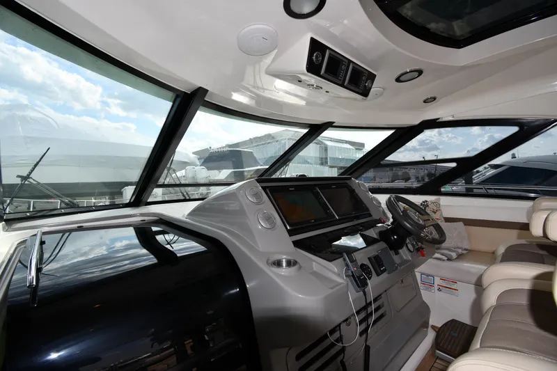 Slide: The Image of Interior view of 2013 Sea Ray Sundancer 540 yacht cockpit with modern controls and seating. - 10