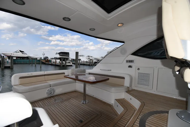 Slide: The Image of Luxurious 2013 Sea Ray Sundancer 540 yacht interior with seating and table, docked at marina. - 14