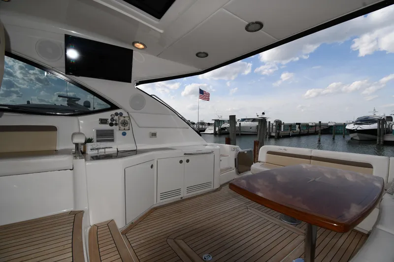 Slide: The Image of Luxurious 2013 Sea Ray Sundancer 540 yacht interior with dockside view and American flag. - 15