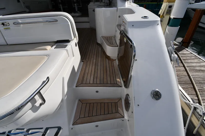 Slide: The Image of 2013 Sea Ray Sundancer 540 yacht deck with teak flooring and seating area. - 21