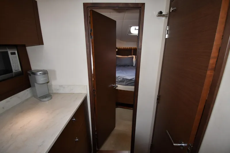 Slide: The Image of 2013 Sea Ray Sundancer 540 interior with kitchenette and bedroom view. - 26