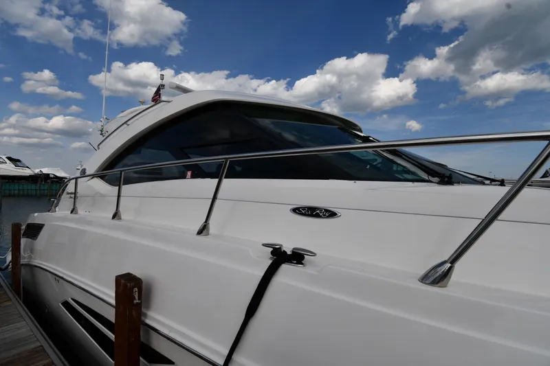 Slide: The Image of 2013 Sea Ray Sundancer 540 yacht docked under a partly cloudy sky. - 3