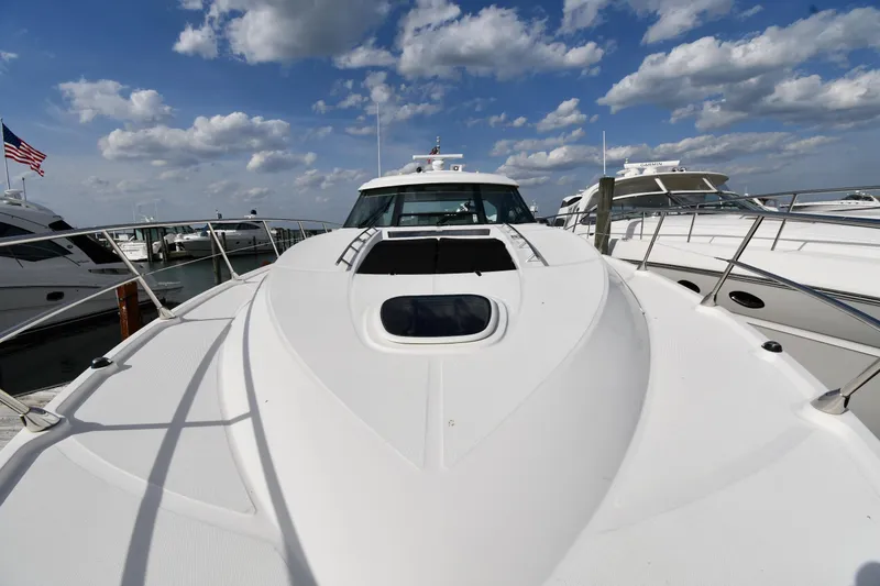Slide: The Image of 2013 Sea Ray Sundancer 540 yacht docked under a partly cloudy sky. - 5