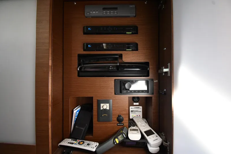 Slide: The Image of Entertainment system controls inside a 2013 Sea Ray Sundancer 540 yacht cabinet. - 51