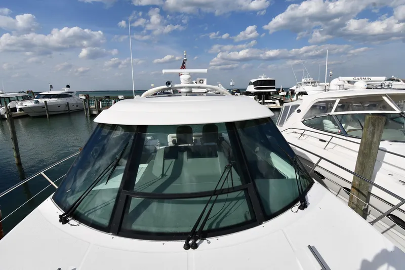 Slide: The Image of 2013 Sea Ray Sundancer 540 yacht docked at marina under blue sky. - 6