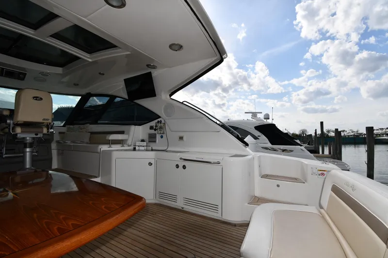 Slide: The Image of Luxurious 2013 Sea Ray Sundancer 540 yacht interior with elegant seating and wooden table. - 8