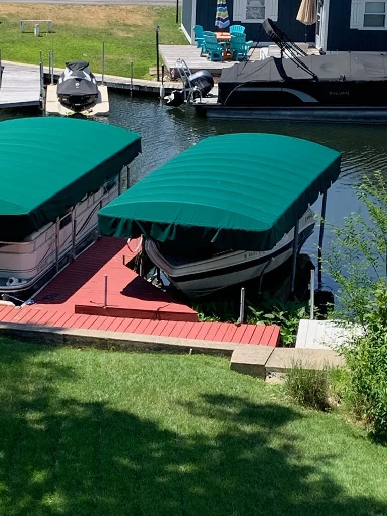 Slide: The Image of 2001 Caravelle Open Bow boat under green canopy at dock. - 3