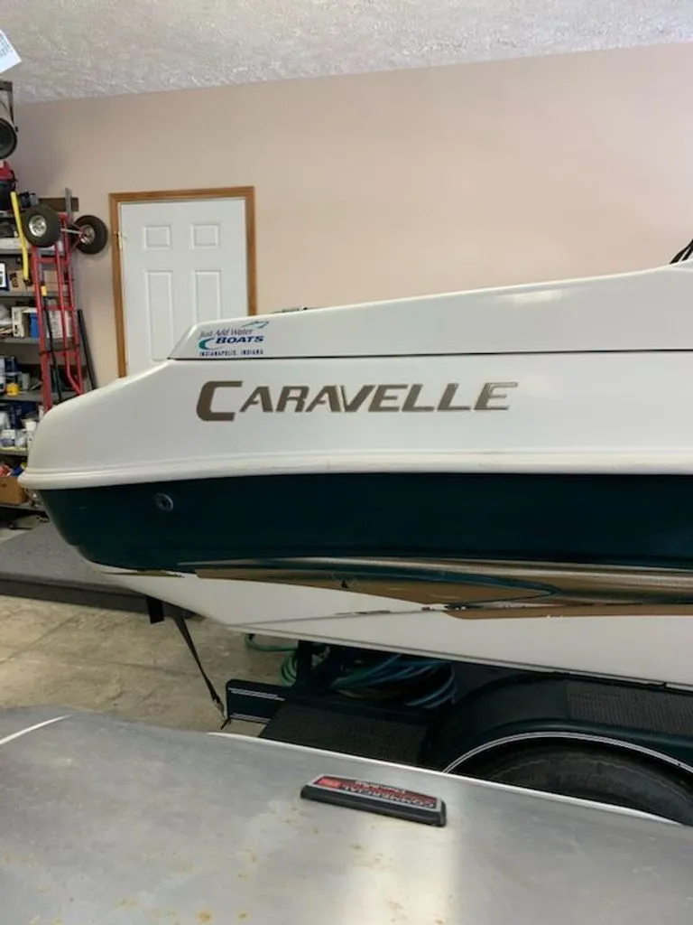 Slide: The Image of 2001 Caravelle Open Bow boat in a garage. - 5