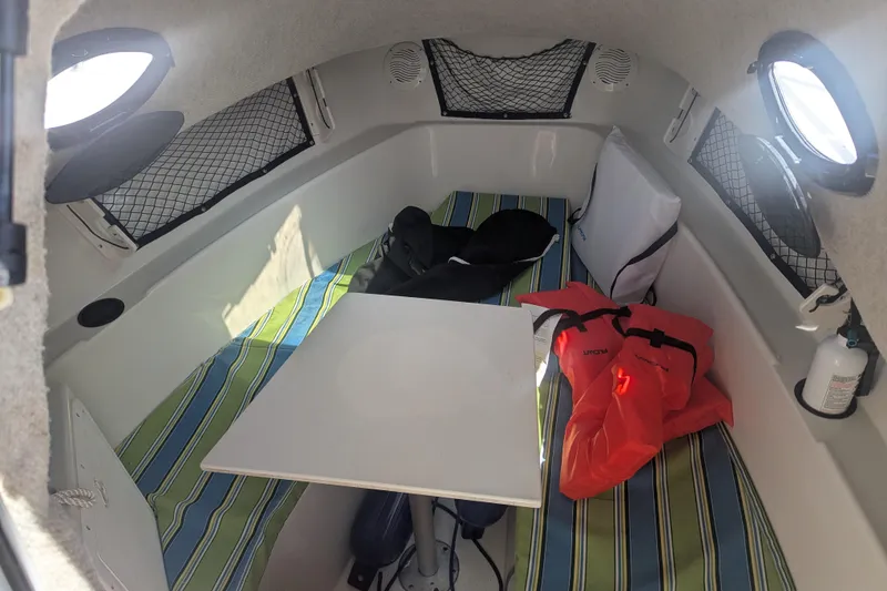 Slide: The Image of Interior cabin of 2005 Sailfish 218 WAC boat with striped cushions and safety gear. - 11
