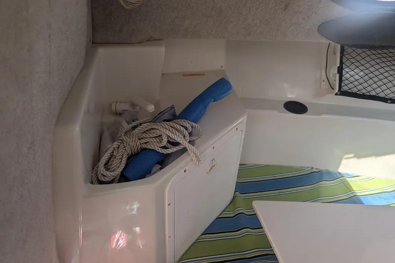 Slide: The Image of Interior of a 2005 Sailfish 218 WAC boat with rope and pool noodle storage. - 12