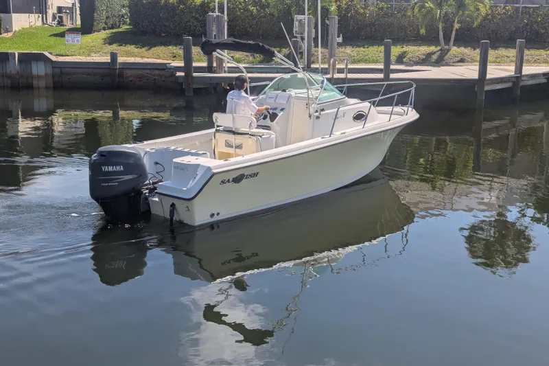 Slide: The Image of 2005 Sailfish 218 WAC boat with Yamaha motor cruising on a calm waterway. - 5