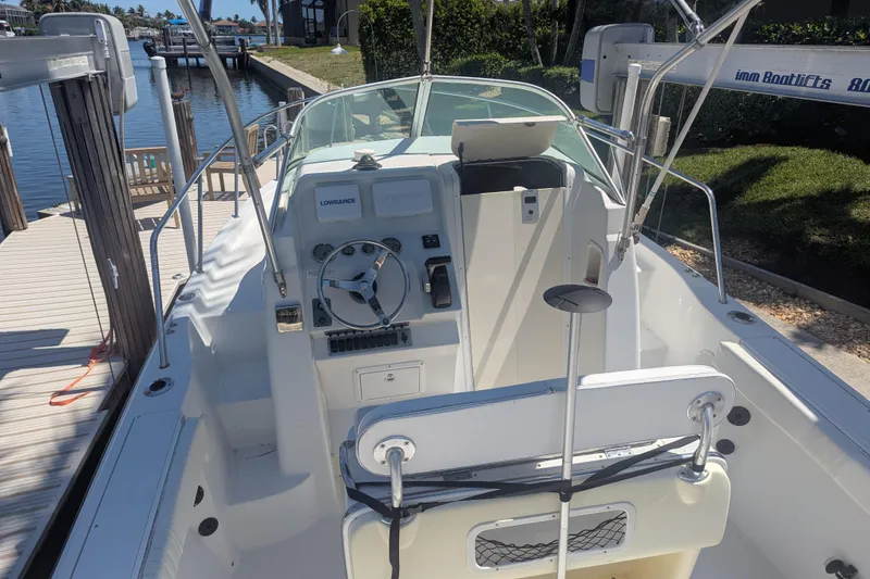 Slide: The Image of 2005 Sailfish 218 WAC boat interior with steering wheel and control panel at dock. - 7