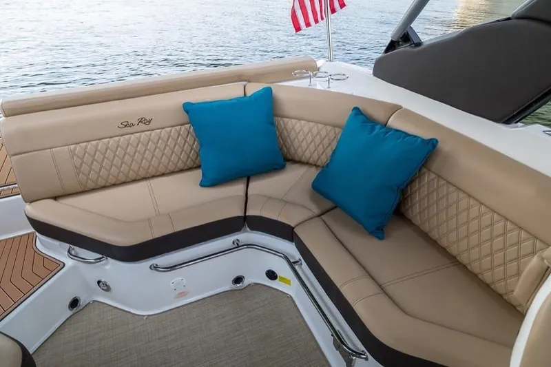 Slide: The Image of Manufacturer Provided Image: 2019 Sea Ray SLX 250 boat interior with tan seating and blue cushions. - 10