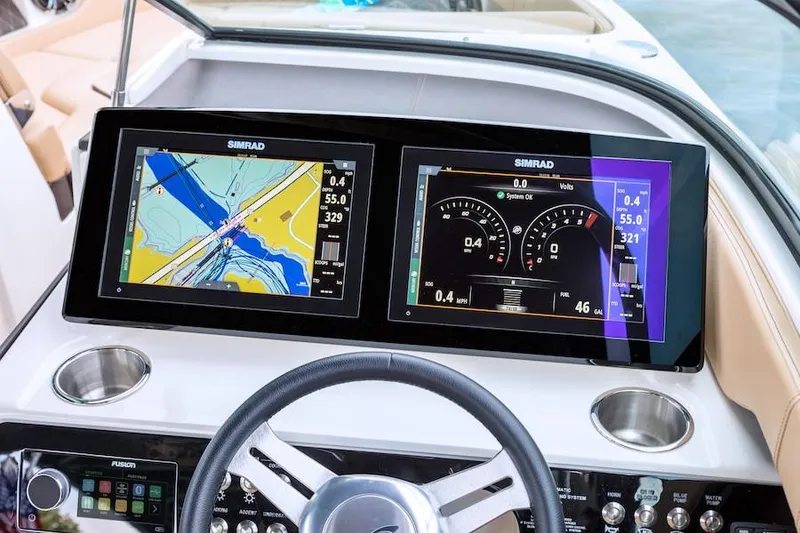 Slide: The Image of Manufacturer Provided Image: 2019 Sea Ray SLX 250 dashboard with dual Simrad displays showing navigation and engine data. - 7