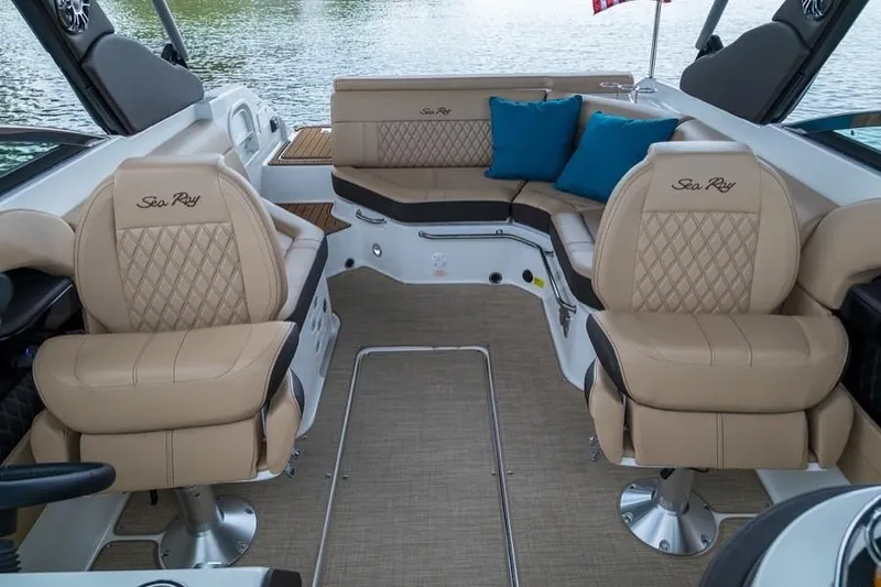 Slide: The Image of Manufacturer Provided Image: 2019 Sea Ray SLX 250 boat interior with beige leather seats and blue cushions. - 9