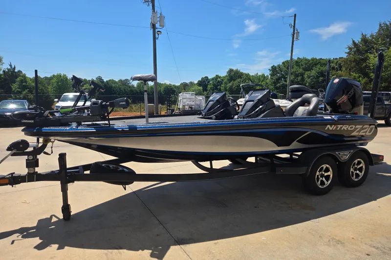 Slide: The Image of 2023 Nitro Z20 Pro boat on trailer, parked outdoors under clear sky. - 2