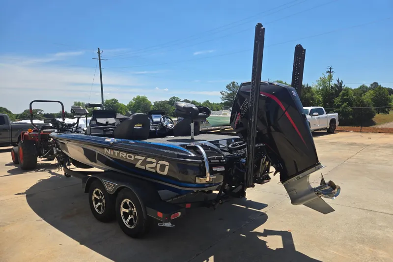 Slide: The Image of 2023 Nitro Z20 Pro boat with powerful outboard motor, parked outdoors on a sunny day. - 21