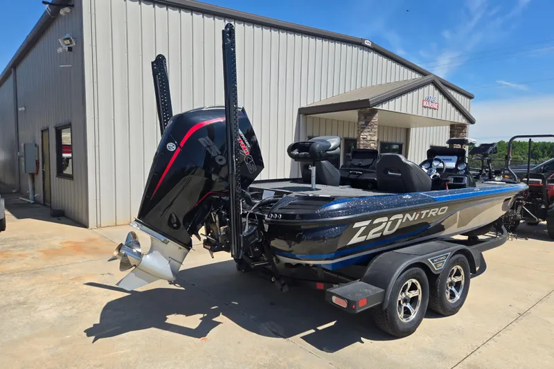 Slide: The Image of 2023 Nitro Z20 Pro boat parked outside a marine dealership on a sunny day. - 23