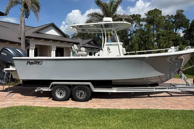 The Image of 2022 Parker 2801 Center Console boat on trailer, parked in front of a house. - 1