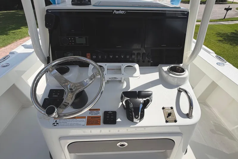 Slide: The Image of 2022 Parker 2801 Center Console boat dashboard with steering wheel and controls. - 10