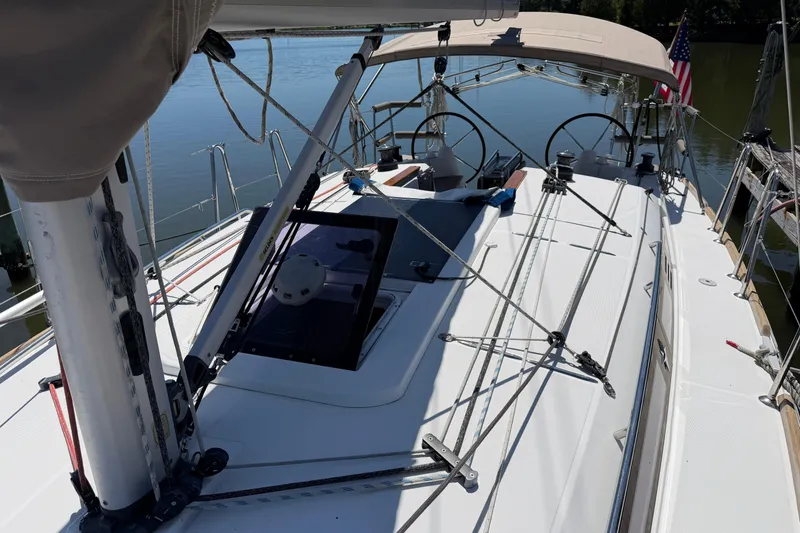 Slide: The Image of 2015 Jeanneau Sun Odyssey 349 sailboat deck with rigging and American flag. - 13