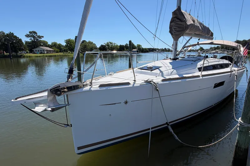 Slide: The Image of 2015 Jeanneau Sun Odyssey 349 sailboat docked on a calm river. - 2