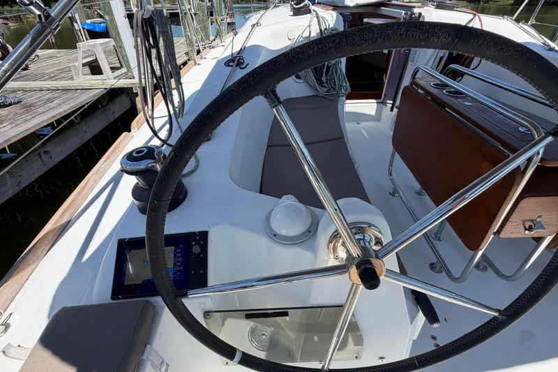 Slide: The Image of Cockpit of 2015 Jeanneau Sun Odyssey 349 sailboat with steering wheel and navigation equipment. - 20