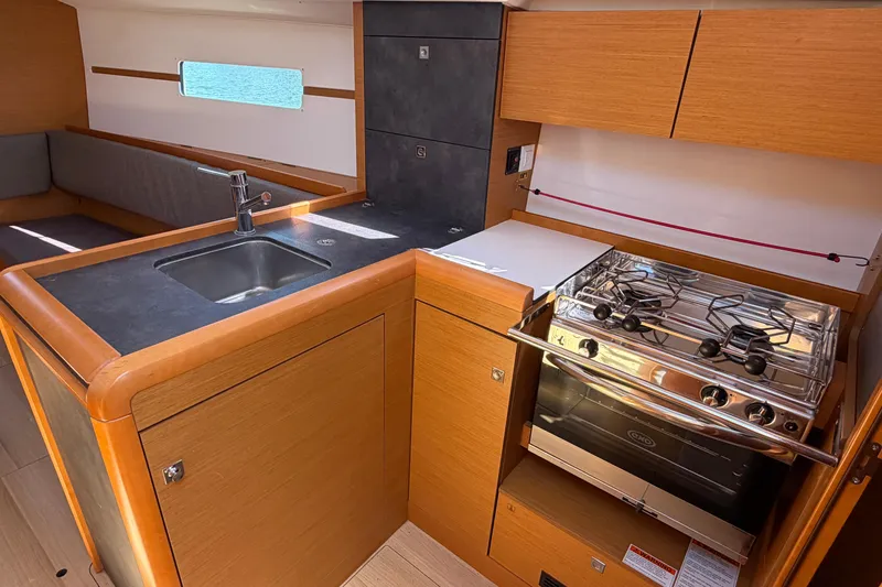 Slide: The Image of 2015 Jeanneau Sun Odyssey 349 yacht kitchen with sink and stove. - 23