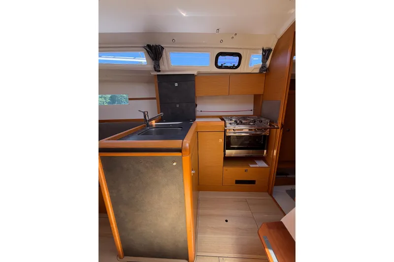 Slide: The Image of Interior of 2015 Jeanneau Sun Odyssey 349 sailboat, featuring a compact kitchen area. - 25