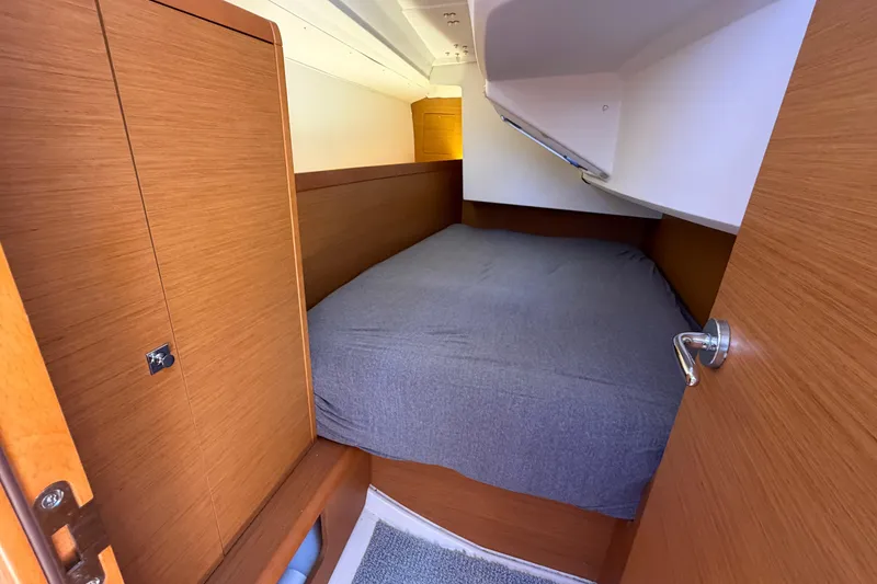 Slide: The Image of Cozy cabin interior of 2015 Jeanneau Sun Odyssey 349 sailboat with wooden finish. - 26