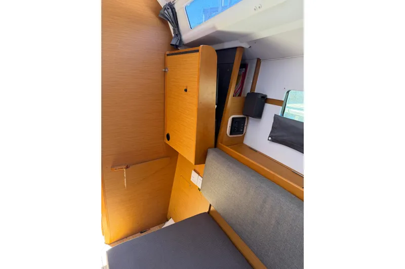 Slide: The Image of Interior of 2015 Jeanneau Sun Odyssey 349 sailboat, featuring wooden cabinetry and seating area. - 30