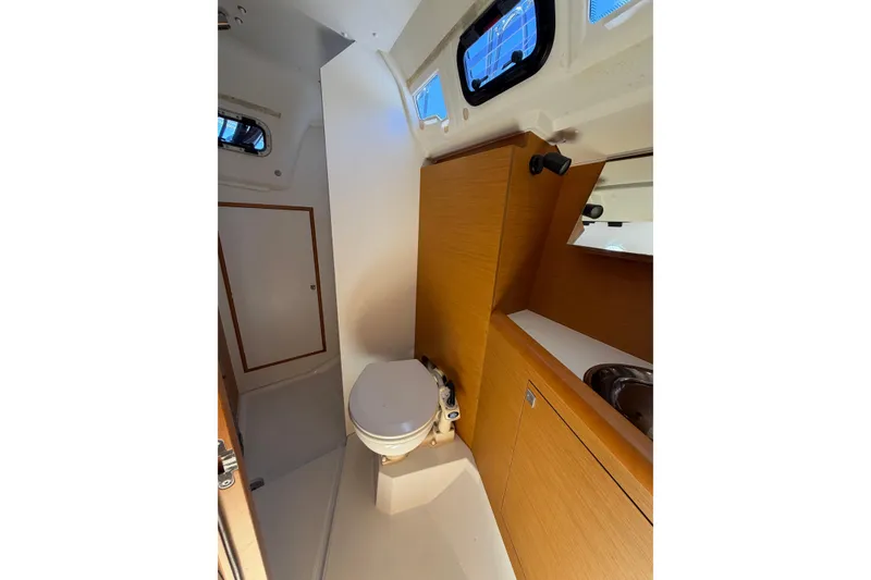 Slide: The Image of Interior of 2015 Jeanneau Sun Odyssey 349 yacht bathroom with wooden cabinetry and compact design. - 31