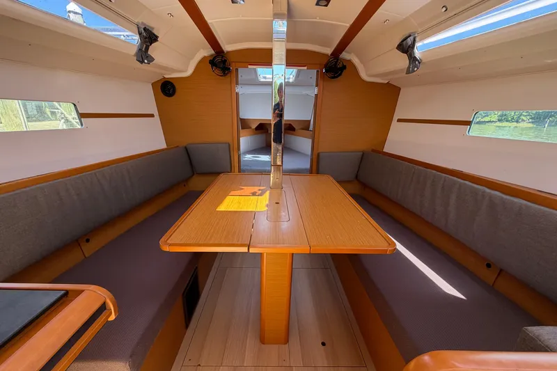 Slide: The Image of Interior of 2015 Jeanneau Sun Odyssey 349 sailboat with wooden table and seating. - 40
