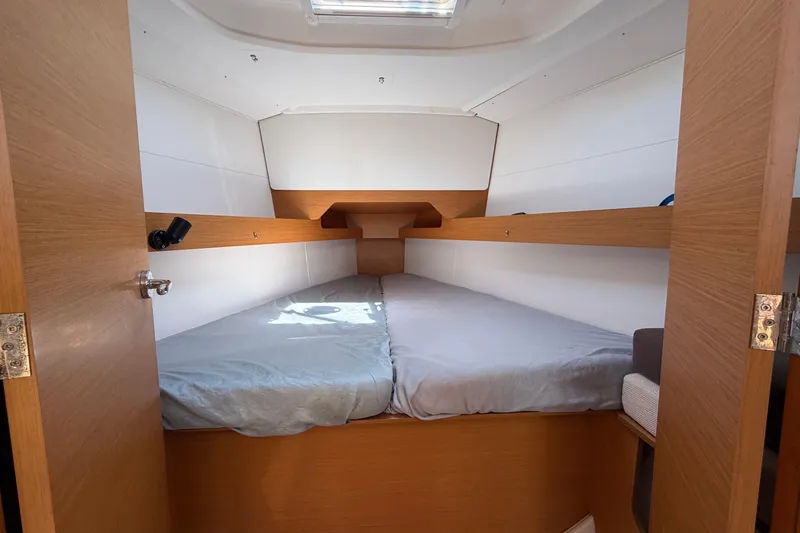 Slide: The Image of Interior cabin of 2015 Jeanneau Sun Odyssey 349 sailboat, featuring cozy twin beds. - 42